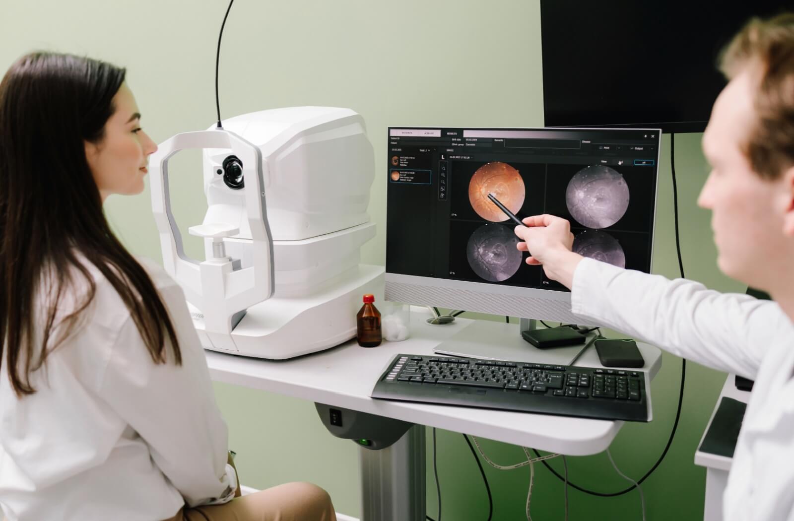 An optometrist goes over the findings of a patient's retinal photos that were taken during their diabetic eye exam.